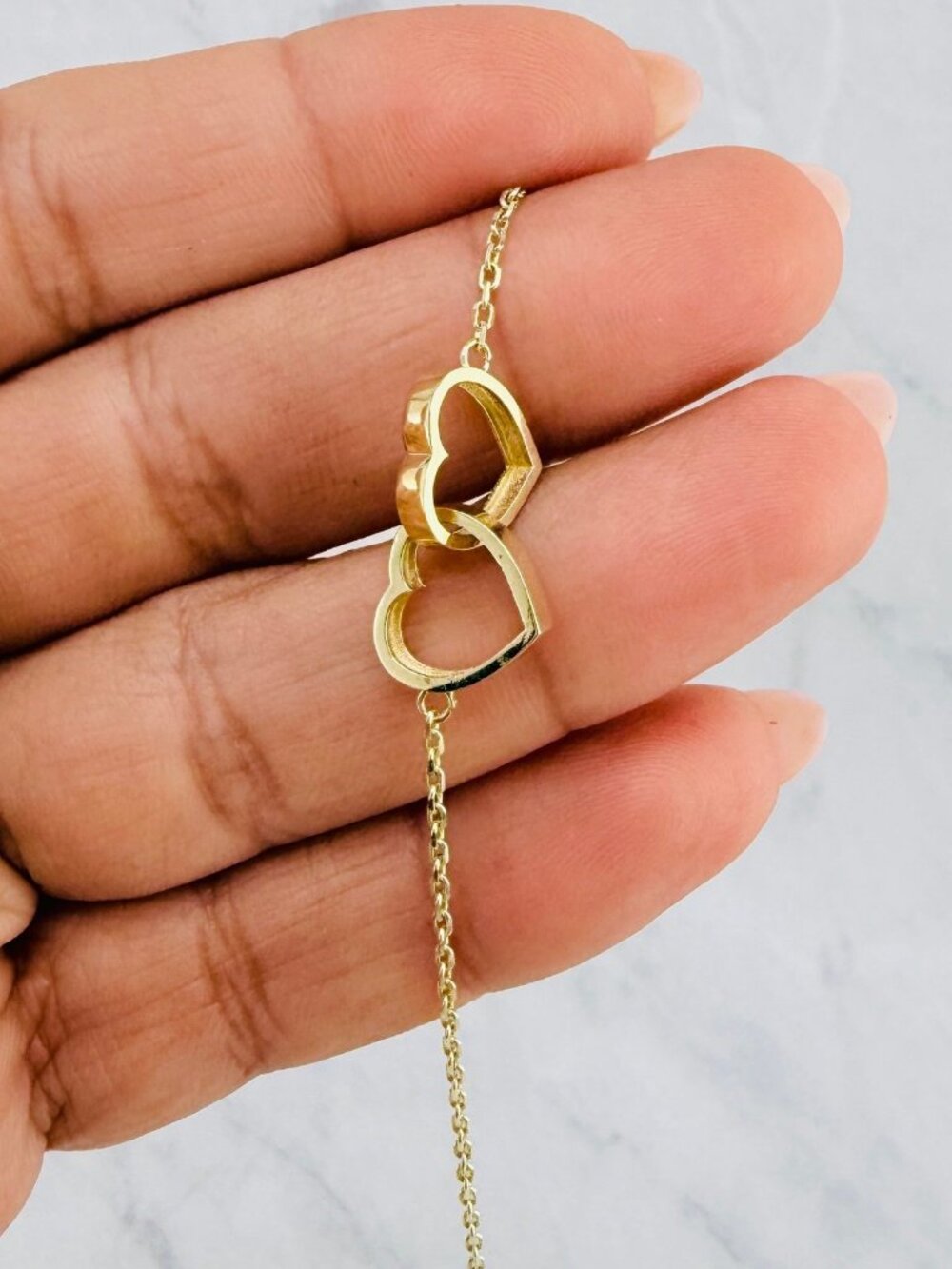 10K gold bracelet features two intertwined hearts 7" - Picture 5 of 6